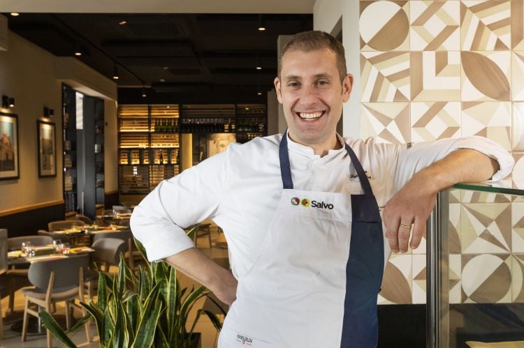 Salvatore Salvo posing in his restaurant