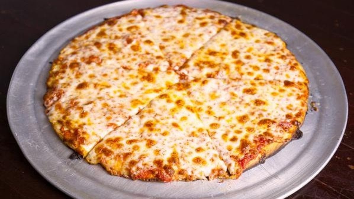 Plain cheese slice at Baby Doll Pizza in Portland's Kerns neighborhood, golden crust built for the fold.